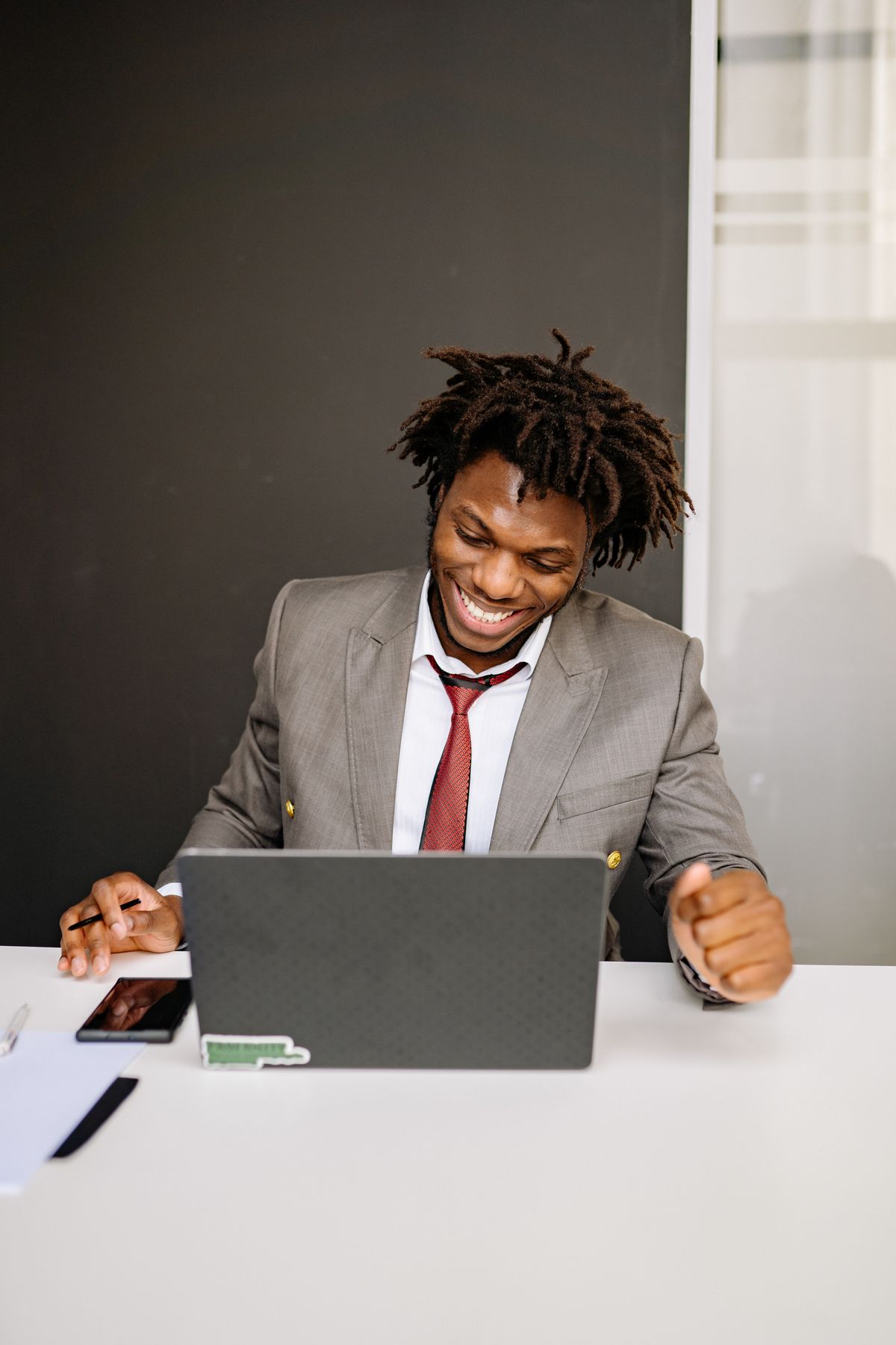 Smiling professional working at his laptop in an office